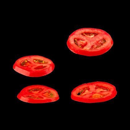 落飞行番茄切片红色的西红柿和黑色的西红柿分开空气中漂浮着轻浮的蔬菜新鲜食物切