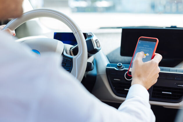 男性现代设备聪明的好人开车时用他的智能手机预测专业流动性