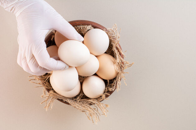 健康新鲜的生鸡蛋放在米色的桌子上生的生蛋壳