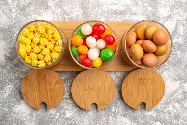 食品不同糖果的俯视图白色表面上五颜六色的糖果鸡蛋营养杏子