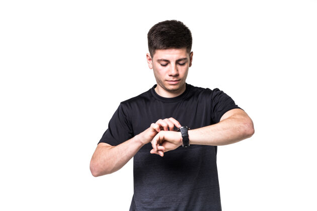 运动一个专注的年轻运动员调整他的手表在白色隔离画像触摸屏健康应用
