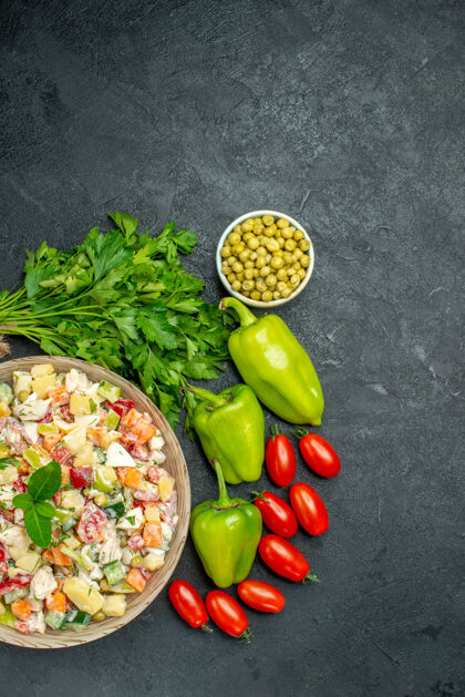 食物一碗蔬菜沙拉的顶视图 在深绿色背景上有绿色和蔬菜番茄晚餐深色
