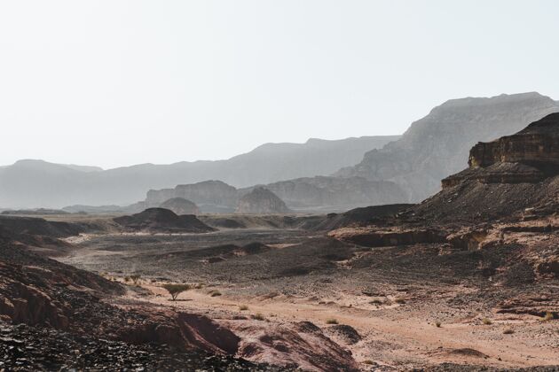 山高角度拍摄沙漠中群山环绕的壮丽群山云沙子草