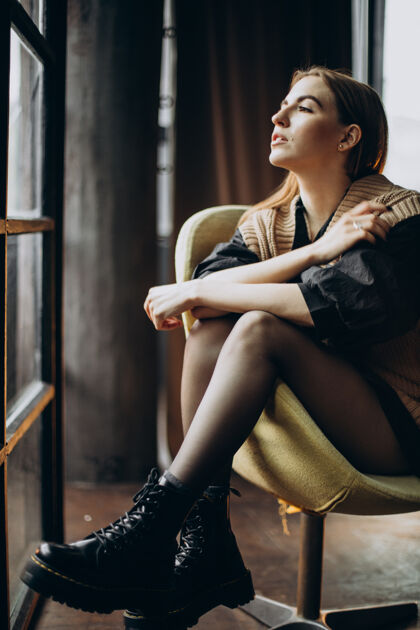 拍摄一个坐在椅子上的年轻女人姿势模特自信