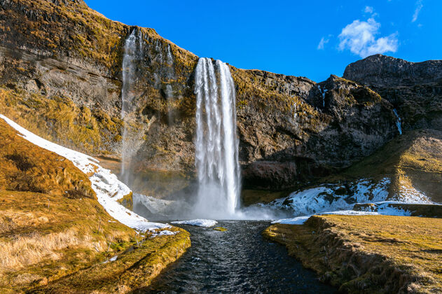 日落塞尔加兰兹福斯瀑布 冰岛美丽的瀑布难以置信天空石头