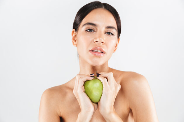 风格美丽的肖像一个迷人的女人拿着绿色的苹果隔离在白色的墙上女人感官吸引力