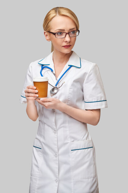 人一位女医生拿着一杯纸咖啡的画像咖啡休息医务人员医生