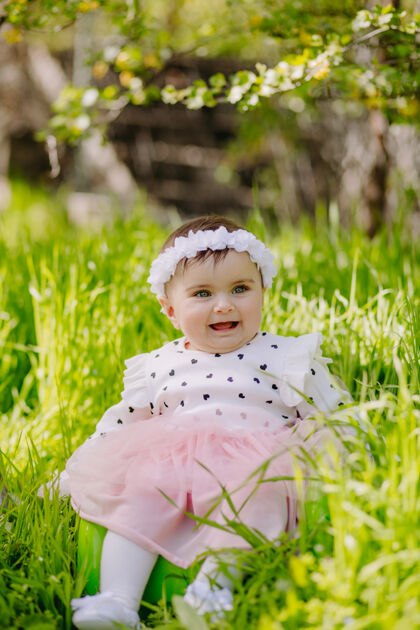 天快乐的六个月大的宝宝满脸幸福的在花园里微笑玩小阳光