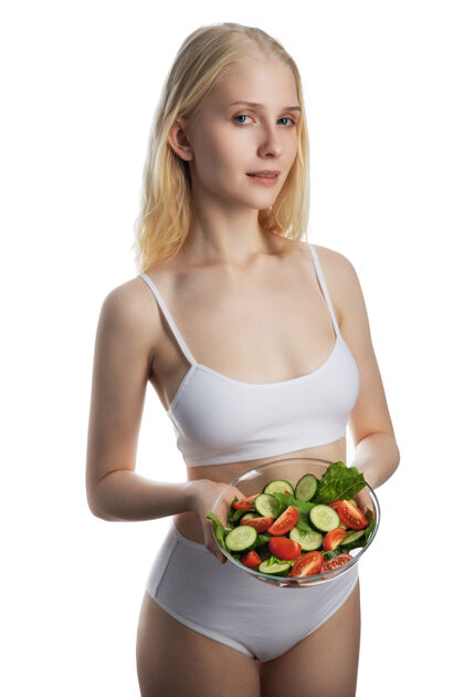新鲜年轻快乐女人吃东西的肖像沙拉健康绿色食品的生活方式吃体重快乐