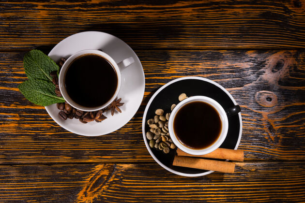 烤从上往下看 在深色的木桌上 红茶和咖啡点缀着树叶 豆子和肉桂条香料早晨早餐