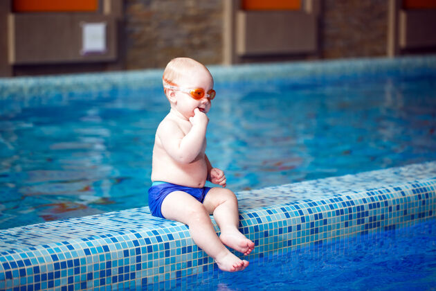 护目镜孩子在游泳池里游泳湿小脸