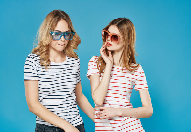 眼镜两个女朋友在条纹T恤太阳镜沟通工作室乐趣时尚休闲欢呼
