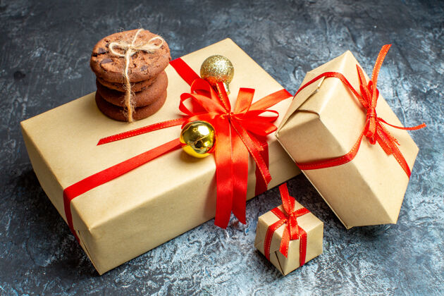 新的前视图圣诞节礼物与甜饼干在光明黑暗的假日照片礼物圣诞颜色新年盒子庆祝年
