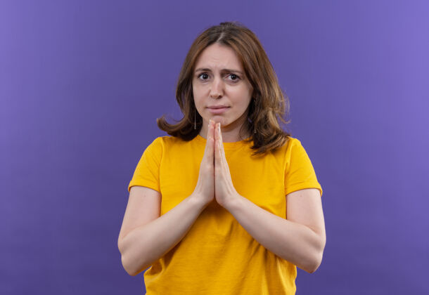 手焦急的年轻随意的女人把手放在祈祷手势上孤立的紫色空间与复制空间焦虑祈祷女人