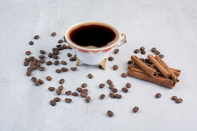 热的一杯咖啡加咖啡豆和肉桂棒豆子咖啡