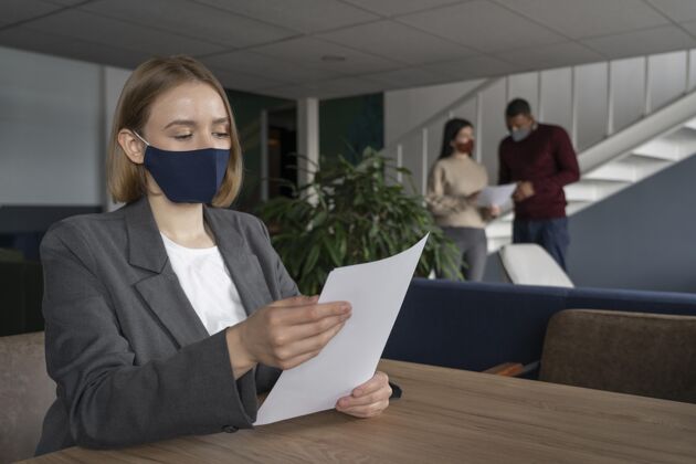 办公室戴着医用面罩的女人在工作工作场所面罩人