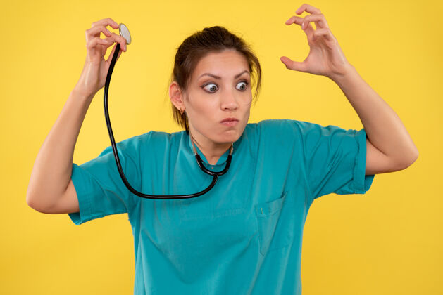 护士正面图黄色背景 穿着医用衬衫 带听诊器的女医生正面女医生视图