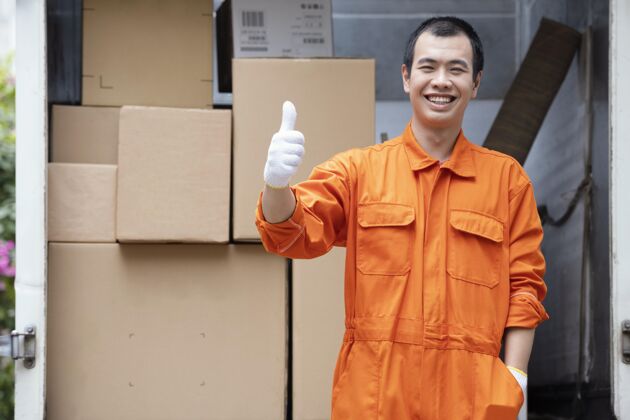 盒子年轻的送货员在送货车里装包裹微笑工人男人