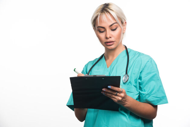人类女医生用白纸笔在剪贴板上写东西医院成人文件夹