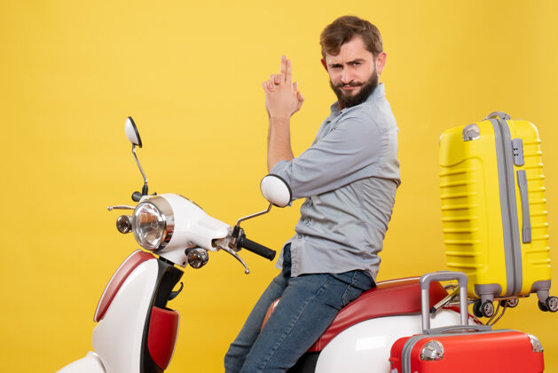 年轻人旅游概念与年轻自信的胡须男子坐在摩托车上 使黄色的势汽车车辆枪
