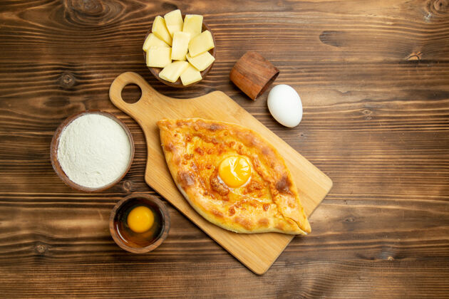 奶酪俯瞰美味的鸡蛋面包烤在棕色的木制书桌上桌子馒头烘焙