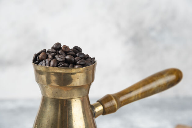 香味在大理石表面放满烤咖啡豆的咖啡壶金属咖啡黑咖啡