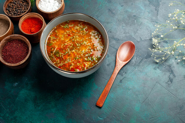 碗顶视图美味的蔬菜汤与不同的调味品上灰面食物餐蔬菜汤配料产品容器木勺汤