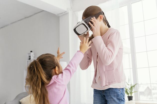 兄弟姐妹两个小妹妹在家玩虚拟现实耳机乐趣孩子室内
