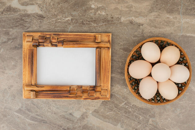 框架大理石桌上放着一篮子白鸡蛋特写鸡蛋多