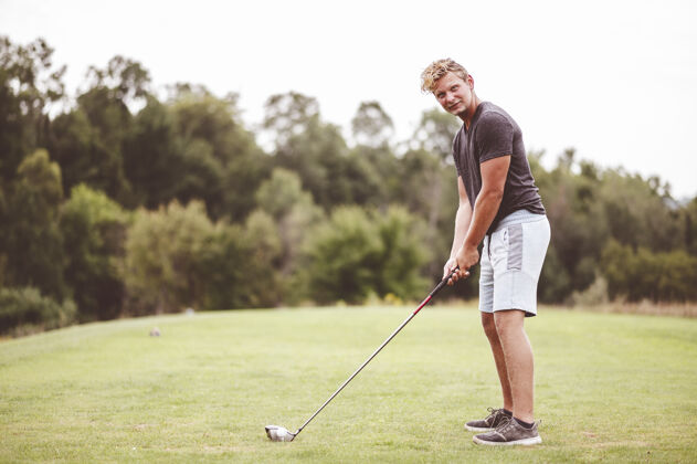 成年人一个年轻人打高尔夫球的特写镜头模糊肖像年轻