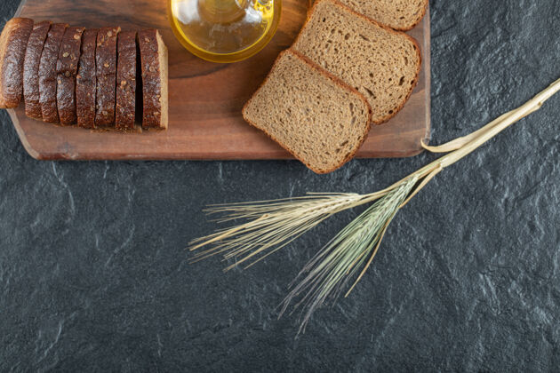 糕点在木板上放几片黑面包和小麦面包房切片木材