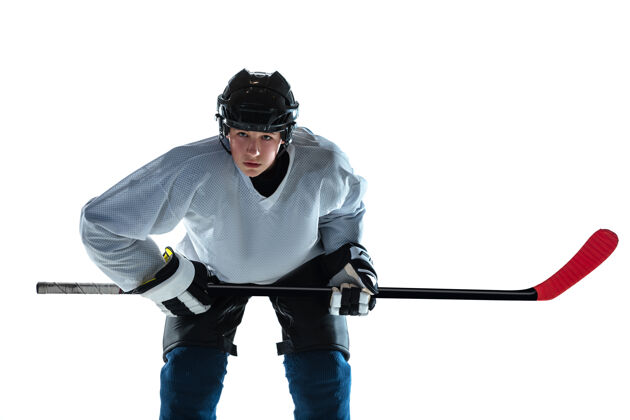 健康严肃的年轻的冰球运动员 冰球场上的棍子和白墙运动员穿着装备和头盔练习运动的概念 健康的生活方式 运动 运动 动作比赛团队运动员