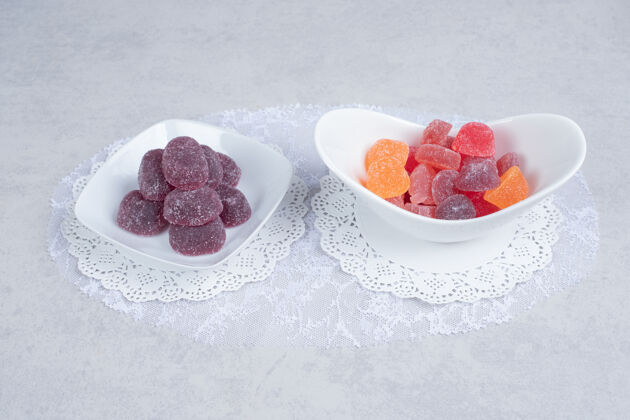 五颜六色白色桌子上摆着一碗碗五颜六色的果酱高质量的照片碗糖果各种