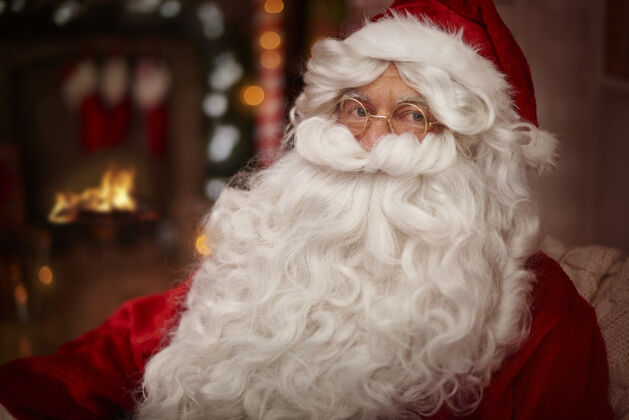 眼镜圣诞老人在壁炉旁热身温暖圣诞装饰沙发