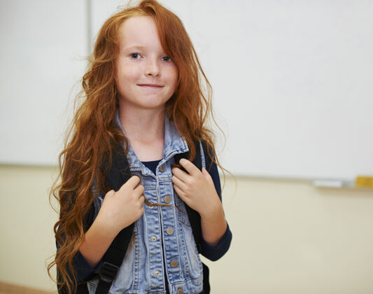 孩子教室里的红头女孩学生站着白板