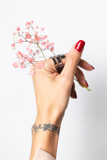 浪漫柔美温柔的照片 女人手上戴着大戒指 红色的指甲 手上拿着可爱的粉色干花女人开花浪漫