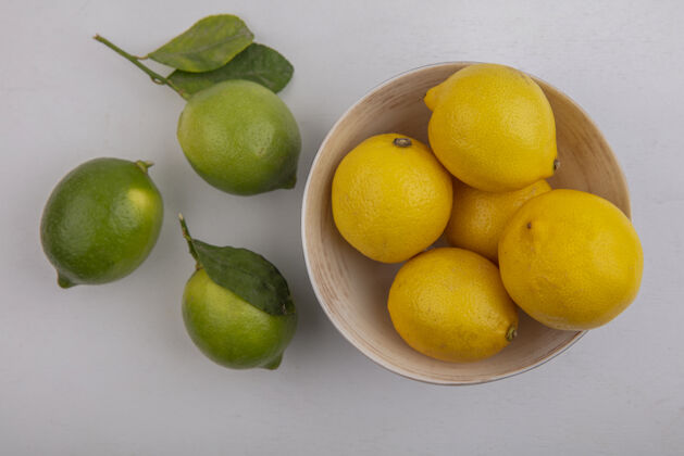新鲜顶视图柠檬在碗与石灰在白色背景顶部酸橙视野