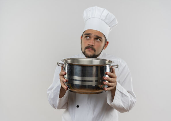 想体贴的年轻男厨师 身着厨师制服 手拿锅碗瓢盆 孤零零地仰望着白色的空间抱着看着厨师