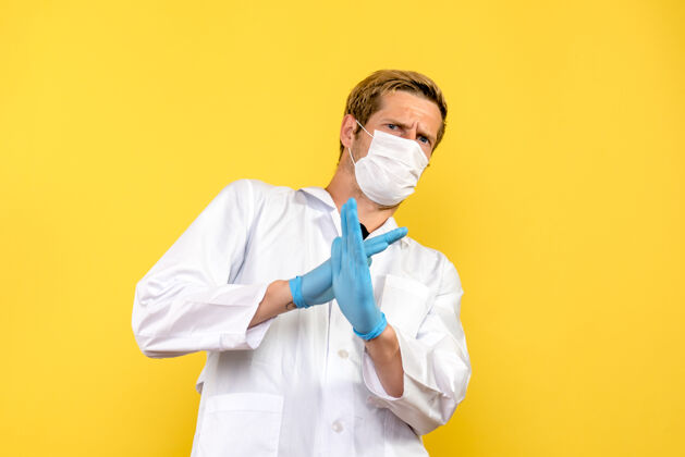 医学正面图男性医生在黄色背景大流行性冠状病毒-健康病毒上显示禁止标志医院听诊器人