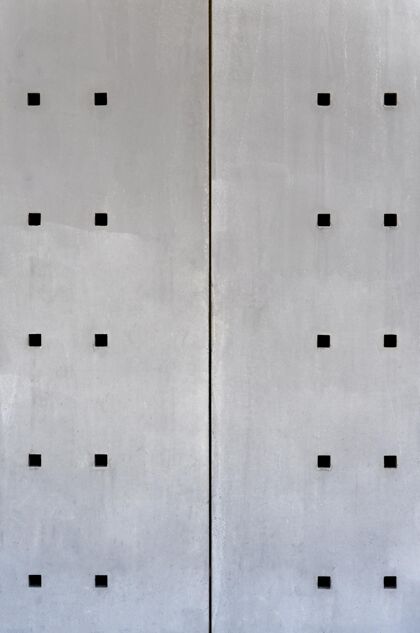 灰色带方孔的抽象钢墙正视图背景金属纹理