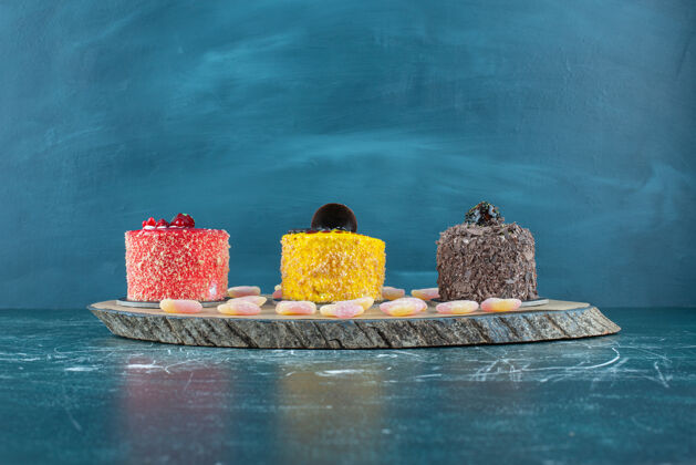 配料蛋糕和肉酱在蓝色的木板上排成一排糕点甜点甜点