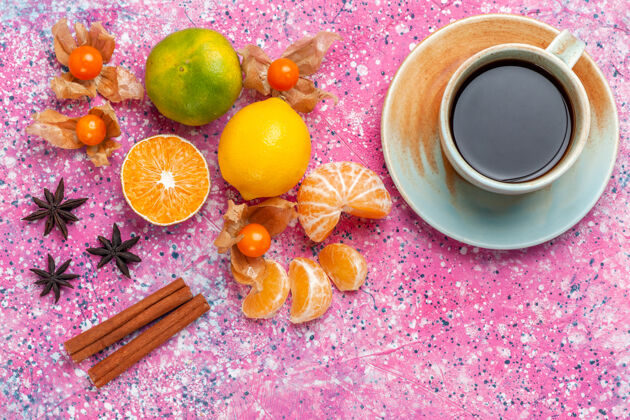 粉色在粉红色的桌子上可以俯瞰新鲜的酸橘子和柠檬以及一杯茶健康橘子柠檬