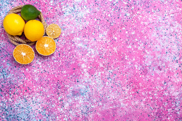 顶部在粉红色的桌子上俯瞰新鲜的黄色柠檬 醇香的酸味水果粉色水果柑橘