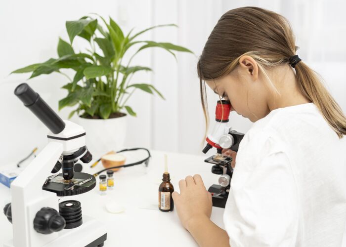 实验女孩看显微镜的侧视图知识女孩科学
