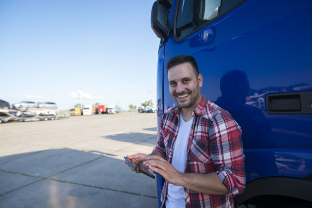 车厢专业卡车司机站在他的平板电脑和设置gps导航下一次乘坐卡车的镜头卡车快速长
