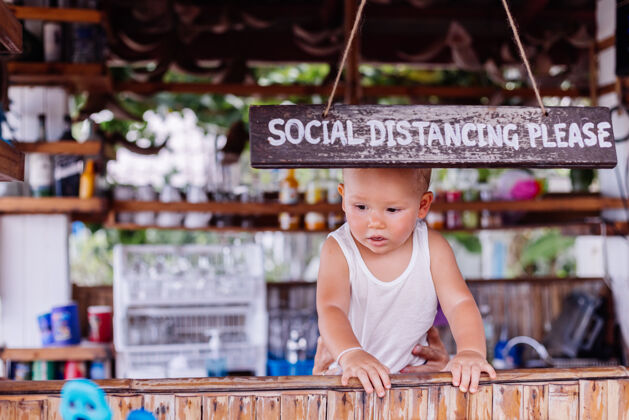 户外在泰国度假的小男婴 在酒吧有社交距离标志冠状病毒年轻正常